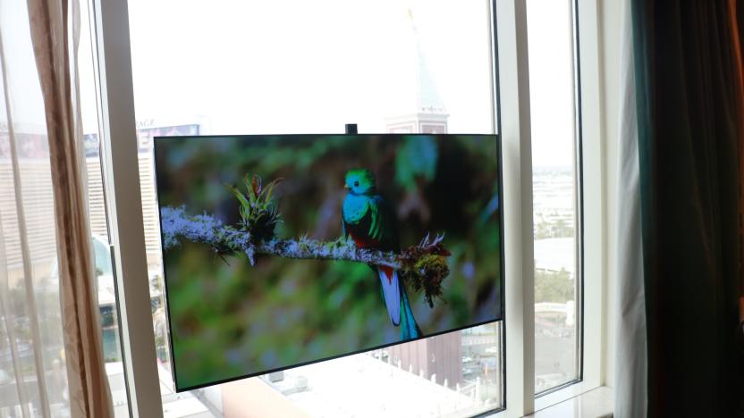 A Displace TV unit attached to large windows.