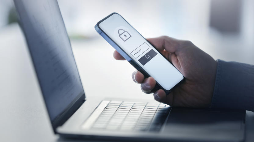 Man holding smart phone with data security on display at office