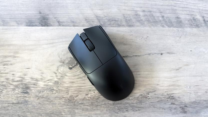 A black Razer Viper V3 Pro gaming mouse rests slightly angled on top of a light brown wooden table.