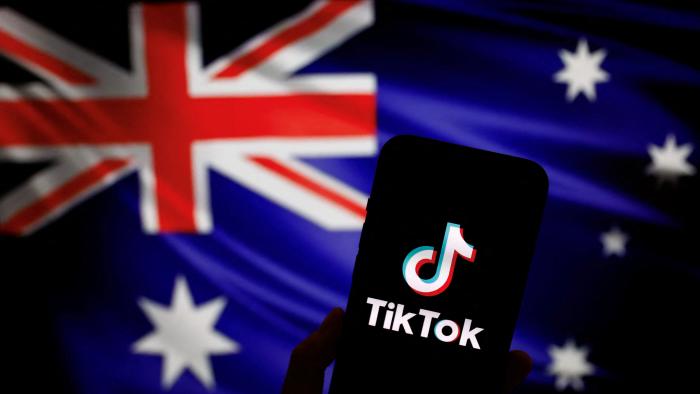 The logo of Chinese-owned video app TikTok is seen on a smartphone in front of an image of the Australian national flag in this illustration picture taken April 4, 2023. REUTERS/Tingshu Wang/Illustration