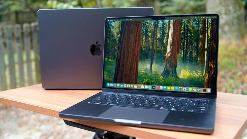 M4 MacBook Pro sitting on a table in a backyard.