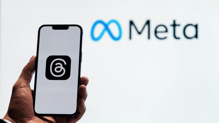 Logo on a phone with Meta sign in background.