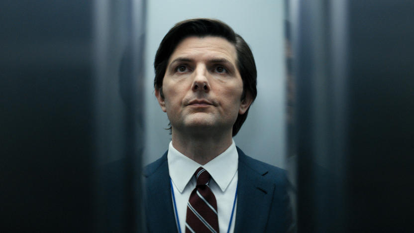 A man wearing a suit stands in an elevator as the doors close in Severance.