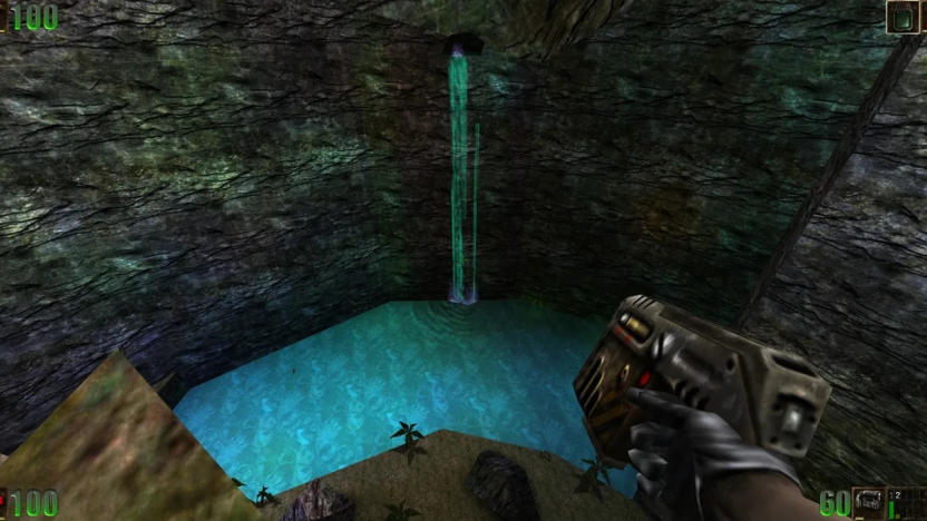 A screenshot from Unreal, showing a waterfall and a small lake at the bottom of a cliff. The player-character is shown from a first-person perspective and is holding a pistol.