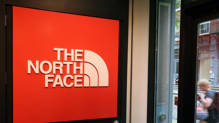 In this Monday, Aug. 13, 2018, a person walks by The North Face store in New York. (AP Photo/Ted Shaffrey)