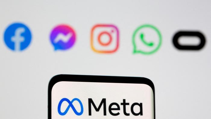 FILE PHOTO: Facebook's new rebrand logo Meta is seen on smartpone in front of displayed logo of Facebook, Messenger, Intagram, Whatsapp, Oculus in this illustration picture taken October 28, 2021. REUTERS/Dado Ruvic/Illustration/File Photo