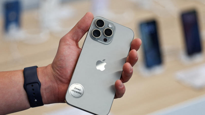 FILE PHOTO: A man holds an Apple iPhone 16 Pro Max ahead of the launch of sales of the new iPhone 16 series smartphones in a store in Moscow, Russia September 20, 2024. The sign on the sticker reads: "Demo model." REUTERS/Evgenia Novozhenina/File Photo